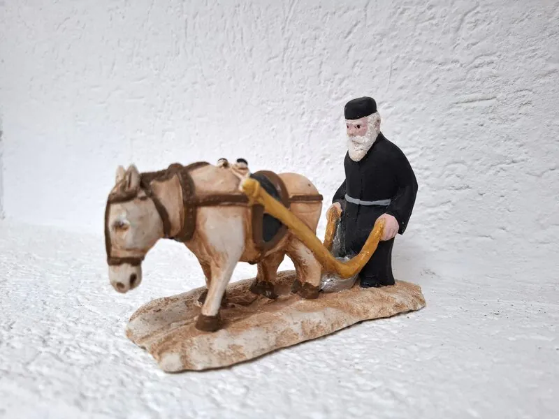 Terakota figurina pravoslavnog svećenika koji ore zemlju uz pomoć magarca